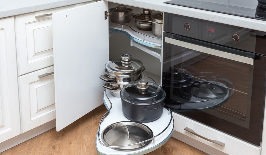 White pull-out shelves in lower cabinets filled with pots and pans