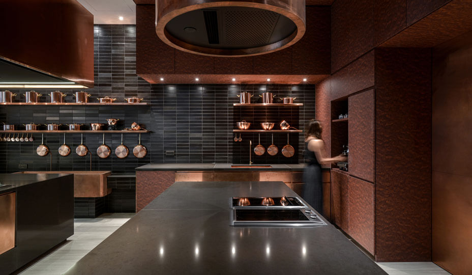 copper kitchen with black ceramic tiling