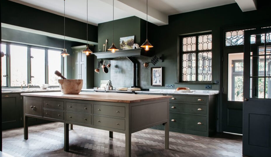 huge kitchen with emerald cabinets and a butcher block island