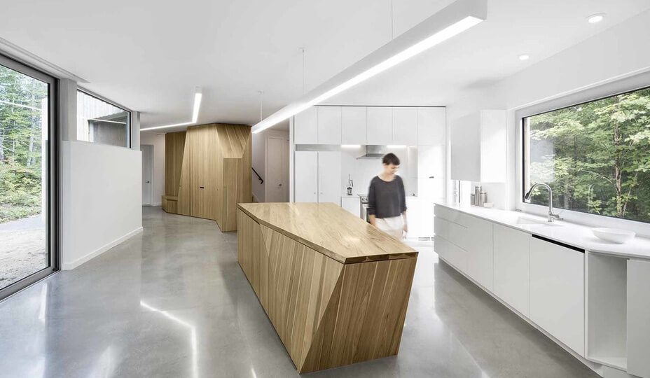 white futuristic looking kitchen with light wood accents