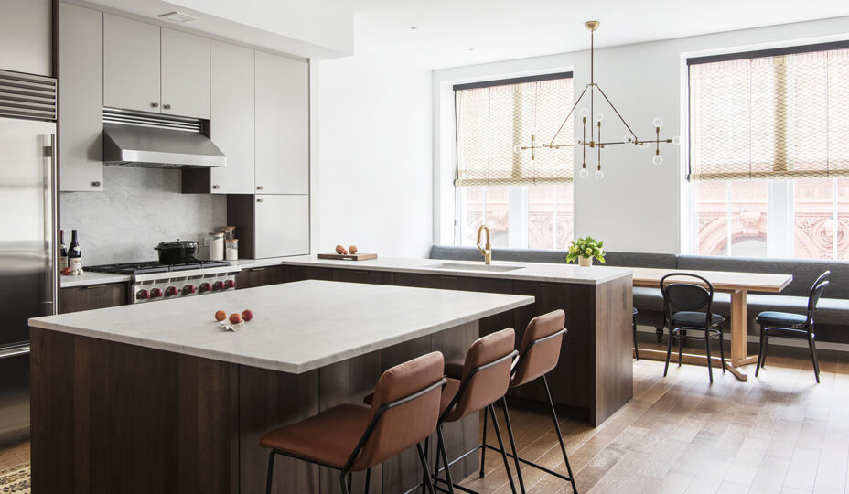 simple kitchen with grey cabinets and leather stools