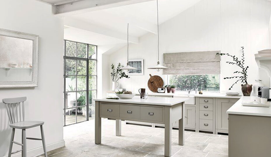 light coloured kitchen with white calls and a kitchen island