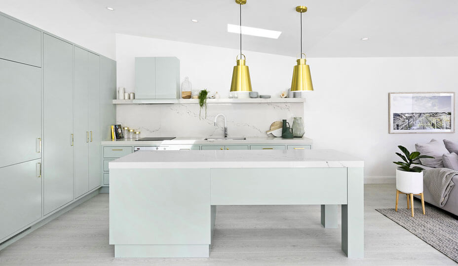kitchen with mint coloured cabinets and golden accessories
