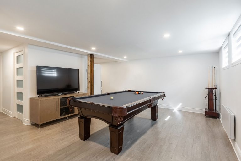 basement renovation with pool table and television
