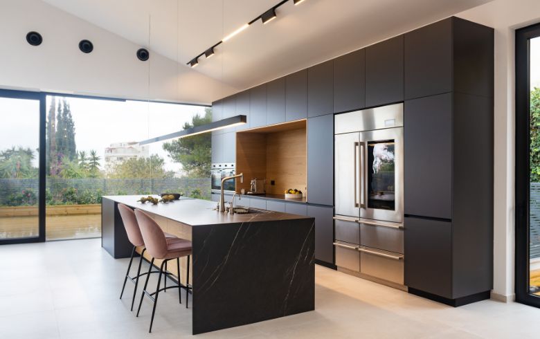 one-wall layout with black cabinets, large island, and stools