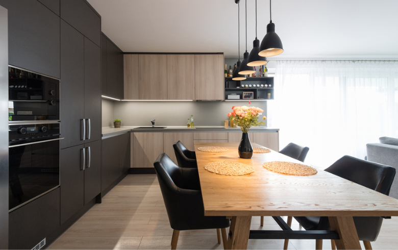 kitchen with black cabinets and wood dinning table