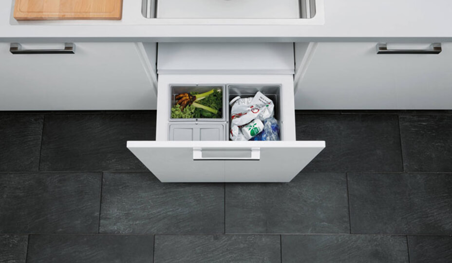 white kitchen with drawer wastebasket with several compartments