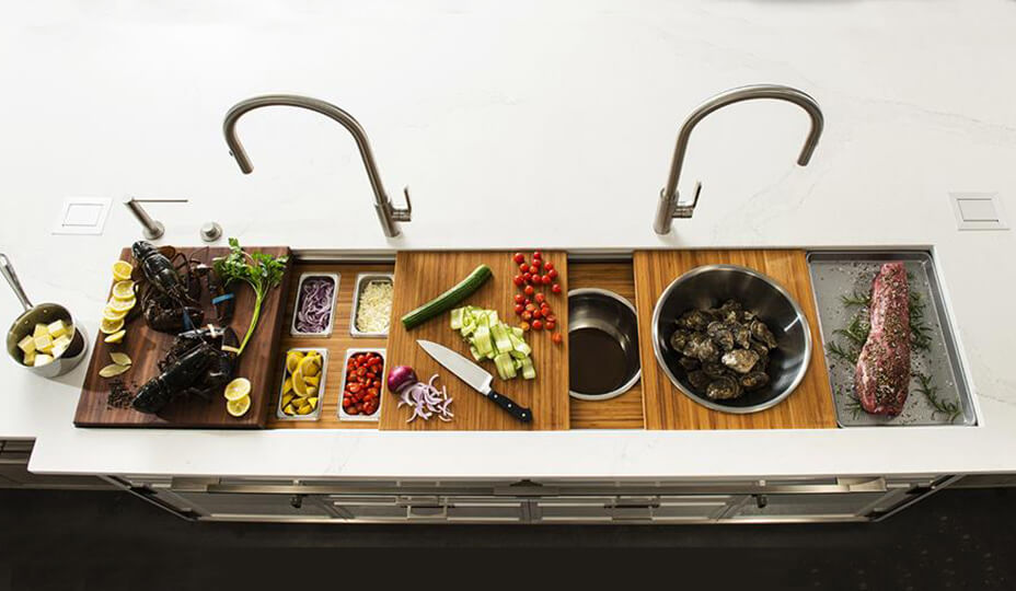 large sink with wooden board with several foods