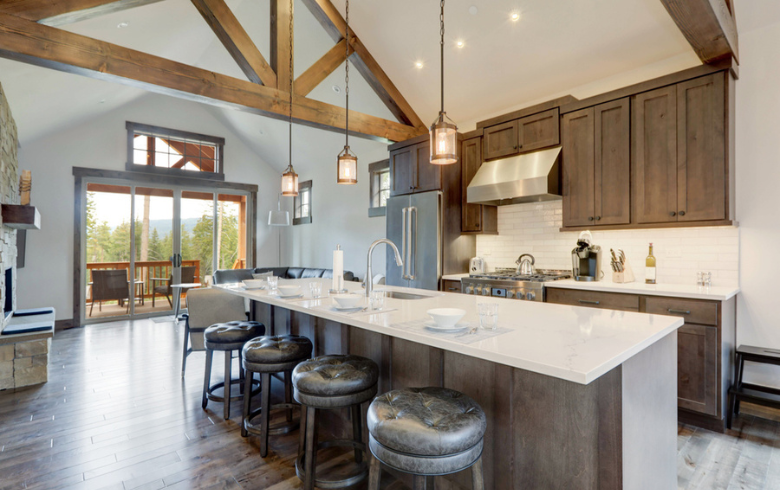 rustic kitchen with wood cabinets and ceiling wood structure