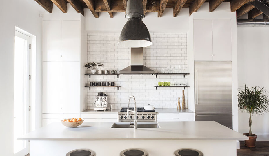white kitchen with white brick and exposed wood beam