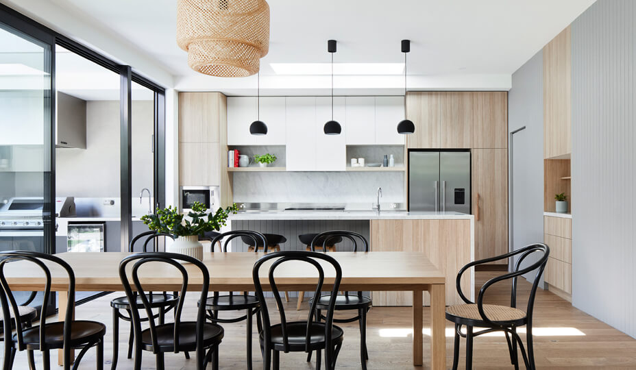 modern kitchen with white and wooden cabinets and black metal chandelier