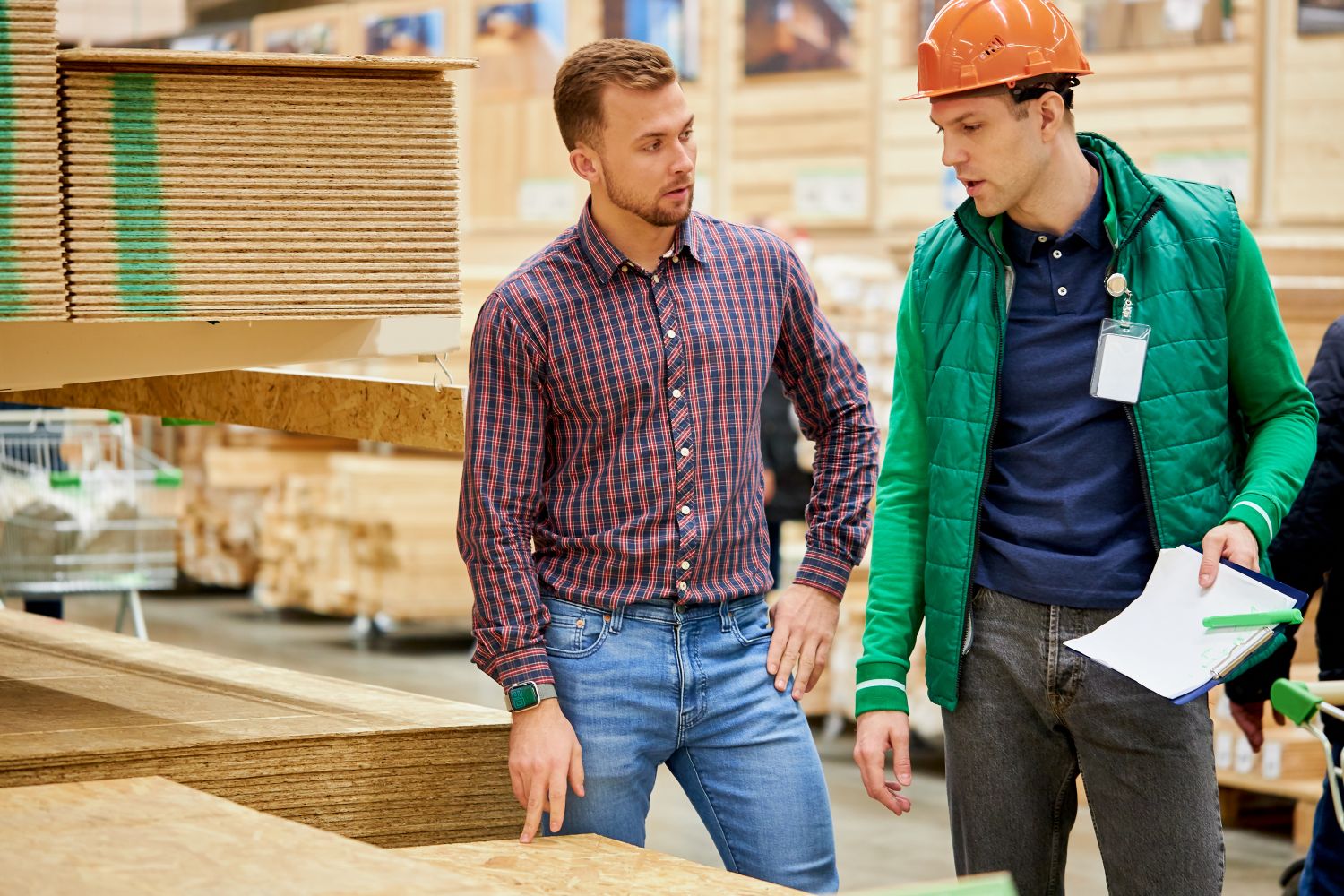 two men talking with construction material around them