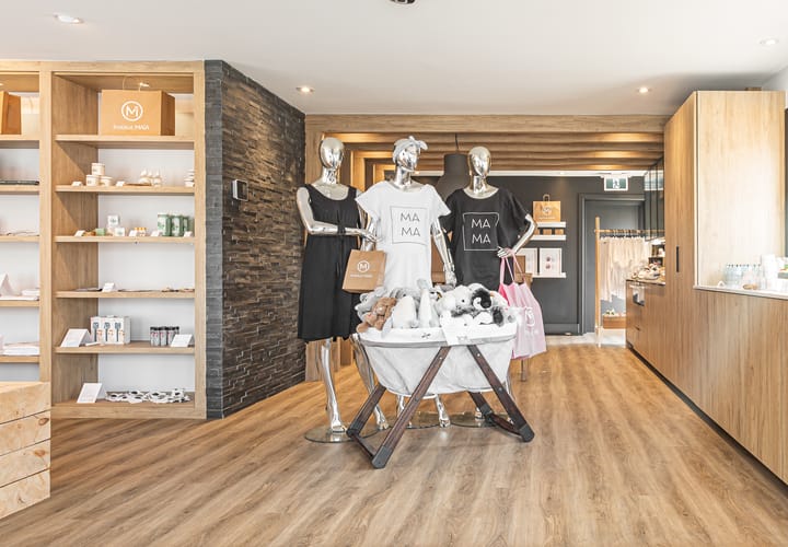 Espace boutique d'une clinique prénatale zen aux accents de bois avec présentoirs
