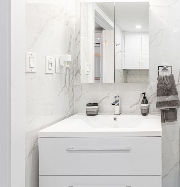 A modern bathroom with a white floating vanity.