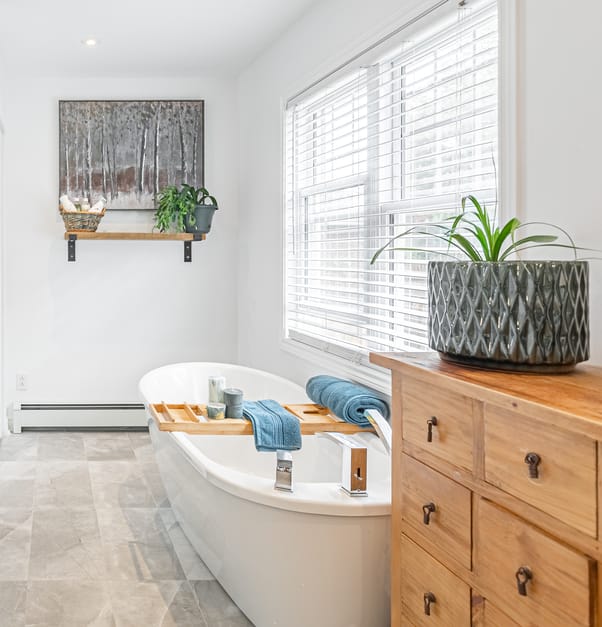 Bathroom with freestanding tub and grey floor tiles