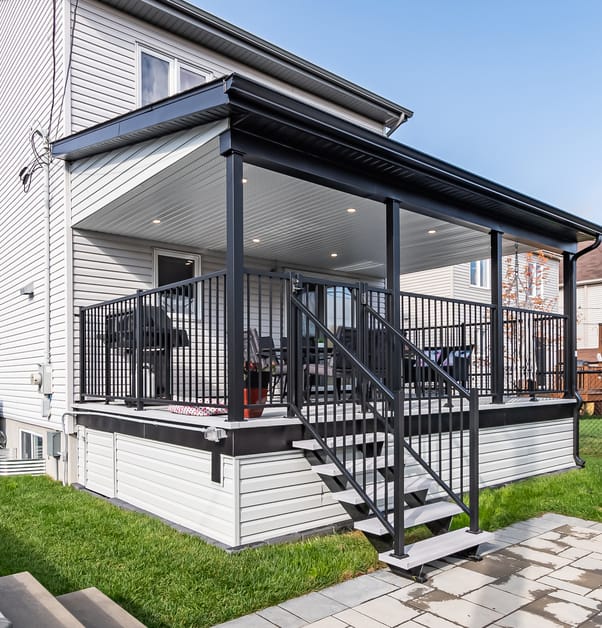 Backyard featuring back porch with black railings