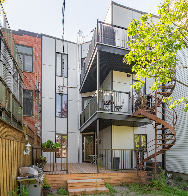 exterior siding of Montreal triplex with wrap-around balconies and deck