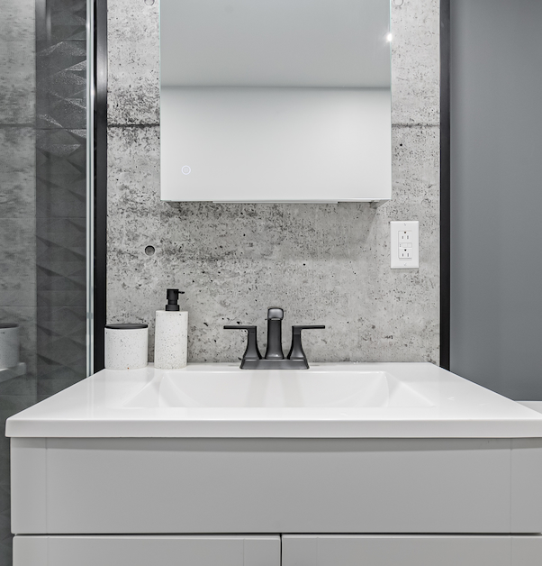 sophisticated vanity with modern concrete accent wall