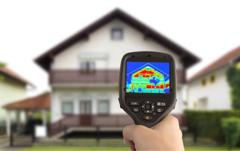 thermal idicator machine pointed at an american-style house