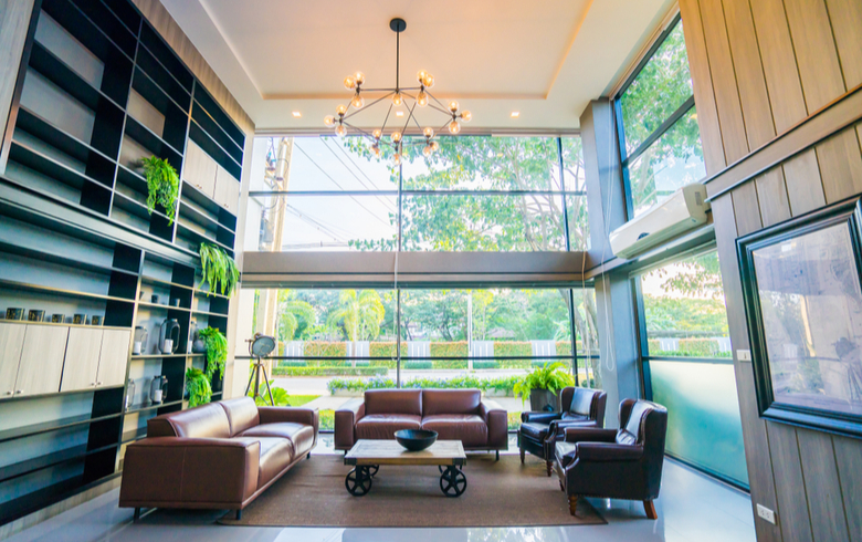 large entrance hall with floor-to-ceiling windows and leather sofas