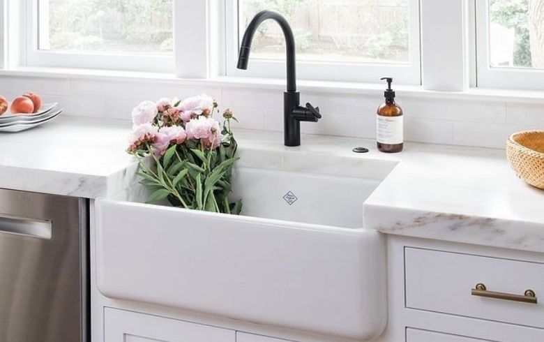 deep farmhouse white kitchen sink with pink peonies