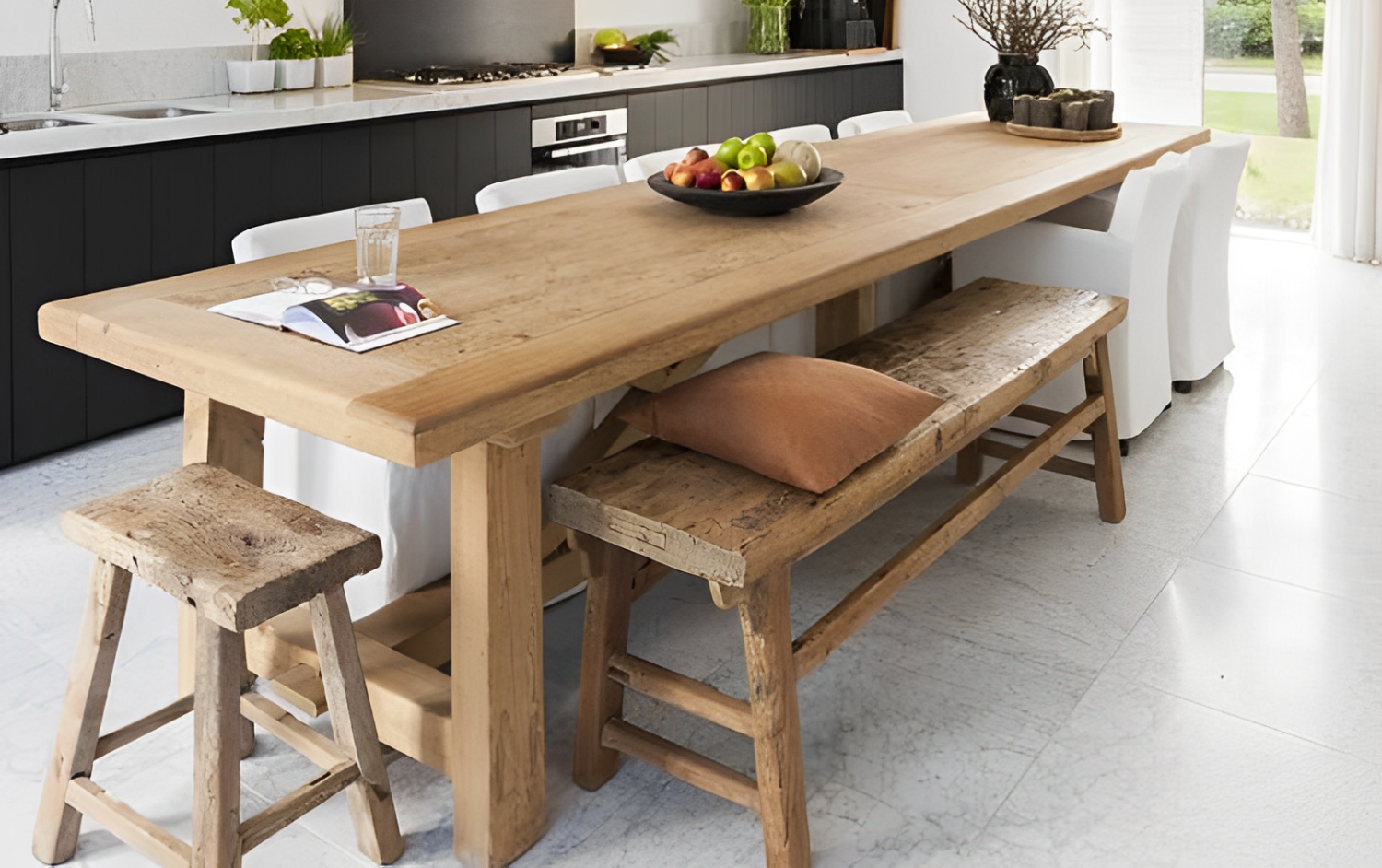 large heavy wood table as kitchen island with wooden benches of same material
