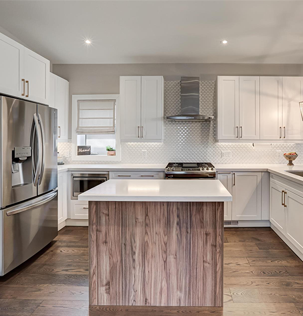Kitchen renovation with white cabinets and wooden island
