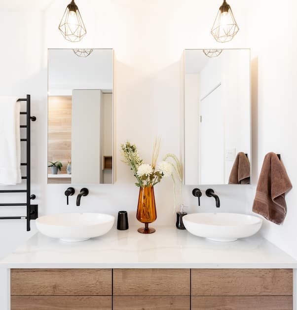 Double vanity in contemporary bathroom renovation with two mirrors