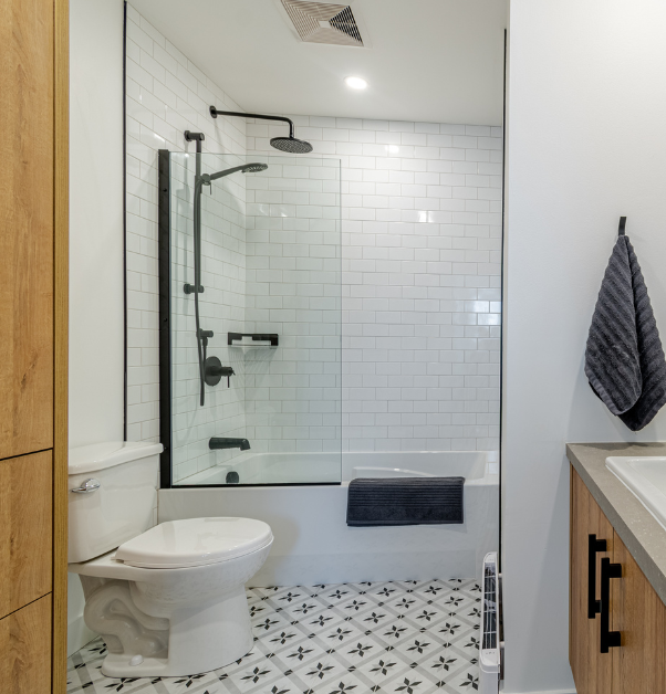 Bath shower with subway tiles and black hardware