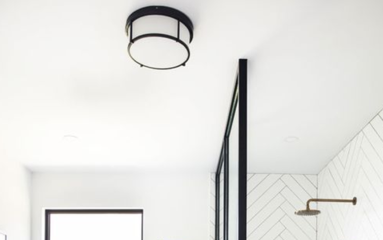 semi-flushed black round ceiling light in bathroom