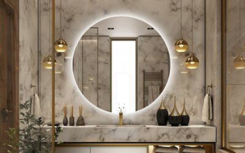 Round mirror against marble wall and above vanity with two pendants on each side