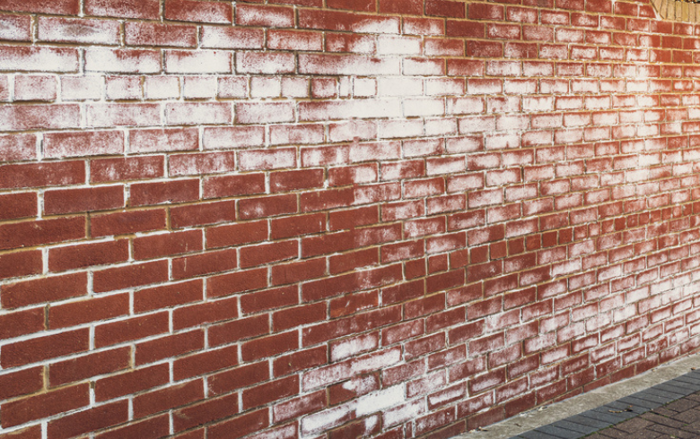 white powder on red brick wall