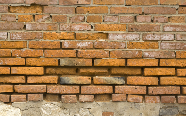 spalling brick on brick wall