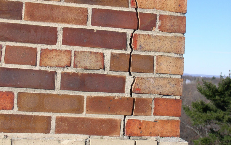 Vertical crack on brick wall