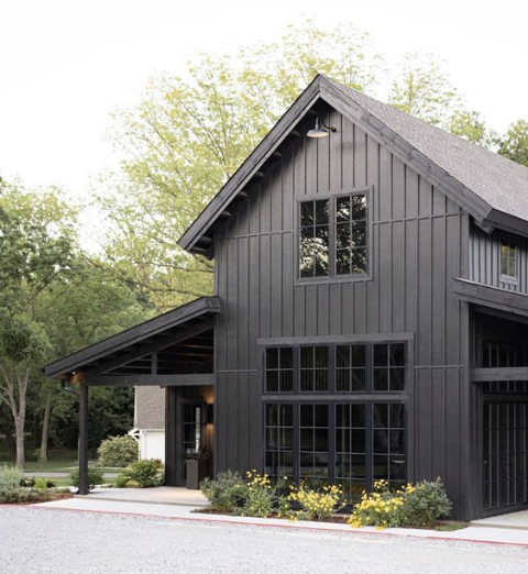Black farmhouse style house with large window