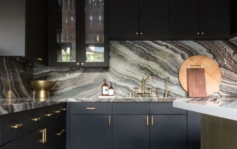 dark kitchen with earth toned resin backsplash and counter that looks like marble