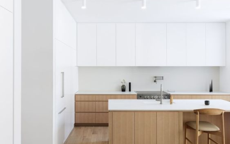 minimalist kitchen with two-toned cabinets and white paint