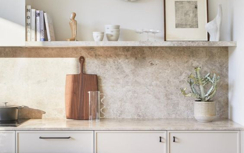 taupe marble backsplash and counter in white kitchen