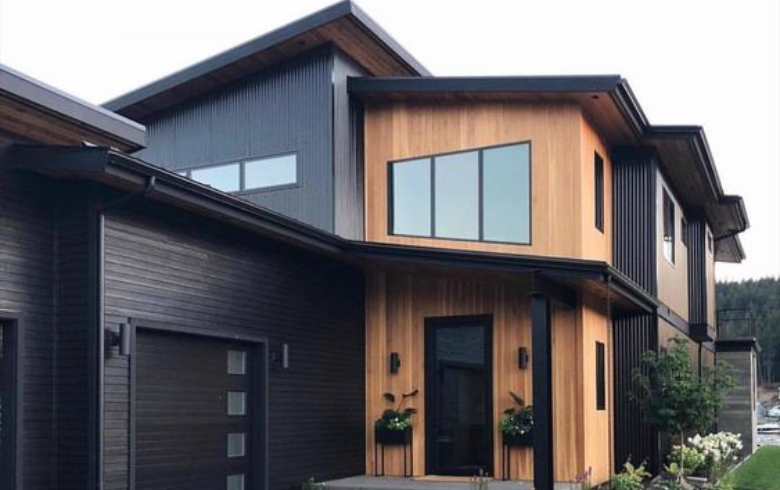 Modern home exterior with wood accent and black steel cladding