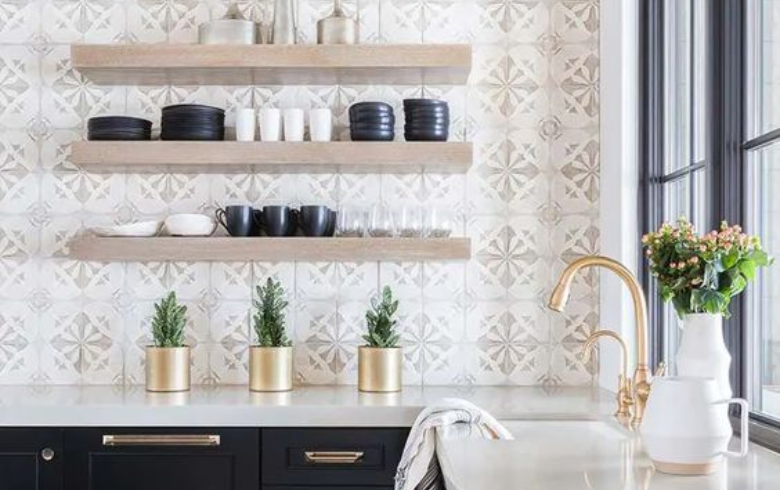 Kitchen with black cabinets, exposed white oak tablets, gold accents and mosaic wallpaper