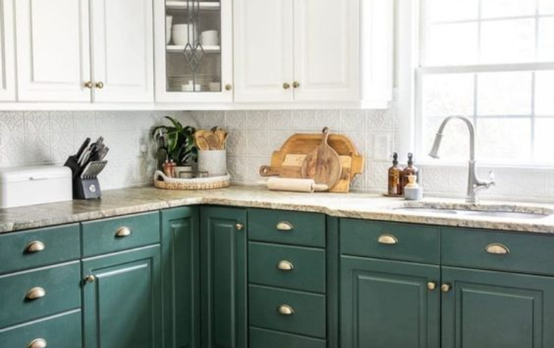 two toned kitchen with dark green, white cabinets and white thermoplastic backsplash