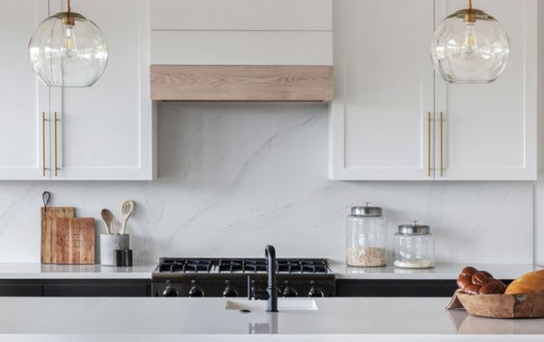 Kitchen with white cabinets and white marble backsplash