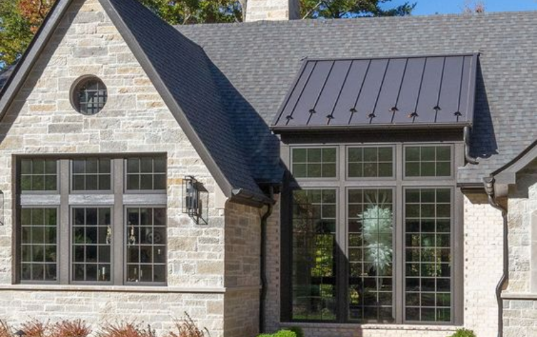 Modern stone house with aluminum roof and shingles