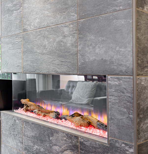 Trendy electric fireplace with flame covered with dark grey square slate tiles