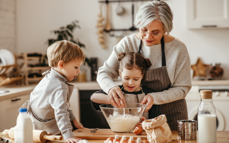 Grandmother baking with grandchildren in  a cozy kitchen
