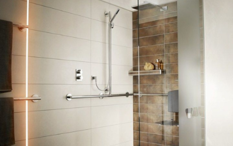 washroom with grab bars and shower seat
