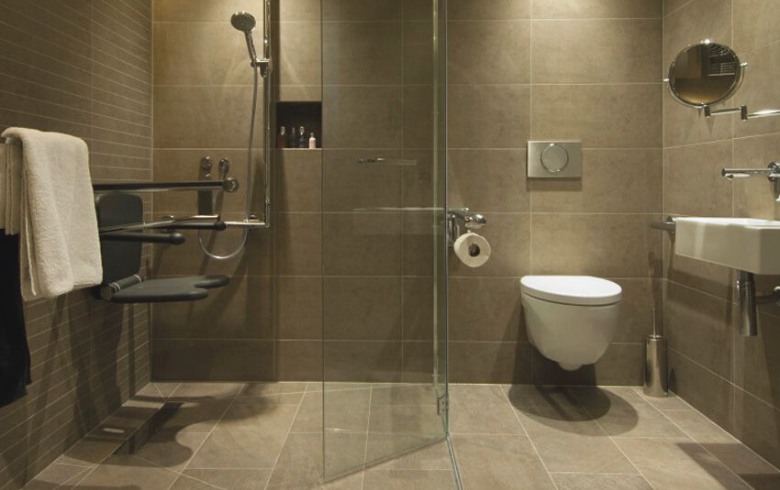 bathroom with large ceramic tiles on walls and floor
