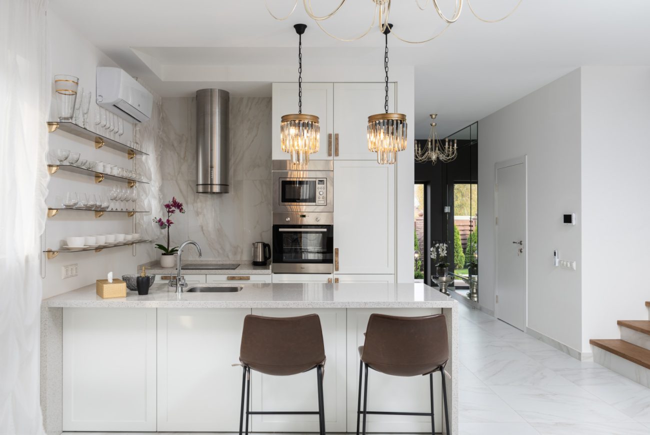 Kitchen with white island and two high stools