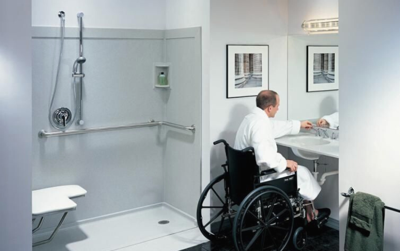wheelchair user washing hands at accessible sink