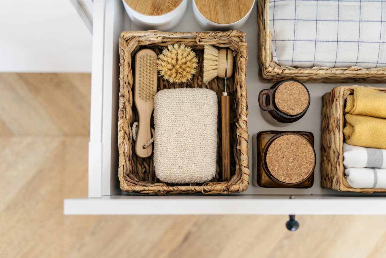 Open drawer, eco-friendly products organized in rectangular woven baskets